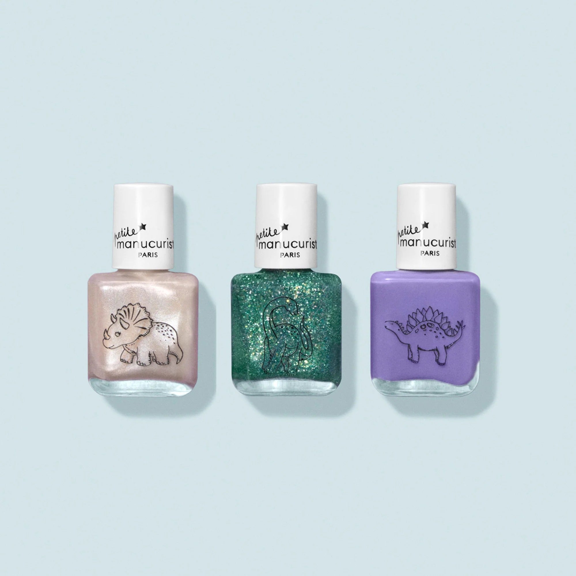 Open Petite Manucurist Wild Life Kit showing three kids’ nail polish bottles in beige, green glitter, and soft violet.