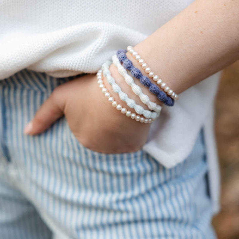 Pearl hair ties worn as bracelet ouchless plant-based elastic #color_ocean-pearl