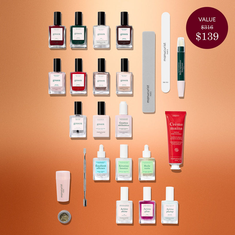 A flat lay of various nail and hand care products—including nail polishes, creams, files, cuticle oil, and tools—featuring the luxurious Active™ Shine Icy from Manucurist’s Advent Calendar Time to Shine! set—arranged neatly on a bronze background. A label notes the set’s value is $139, marked down from $316.